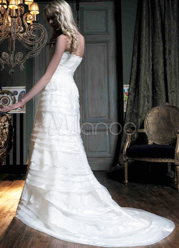 white wedding dress with ruffles and satin band